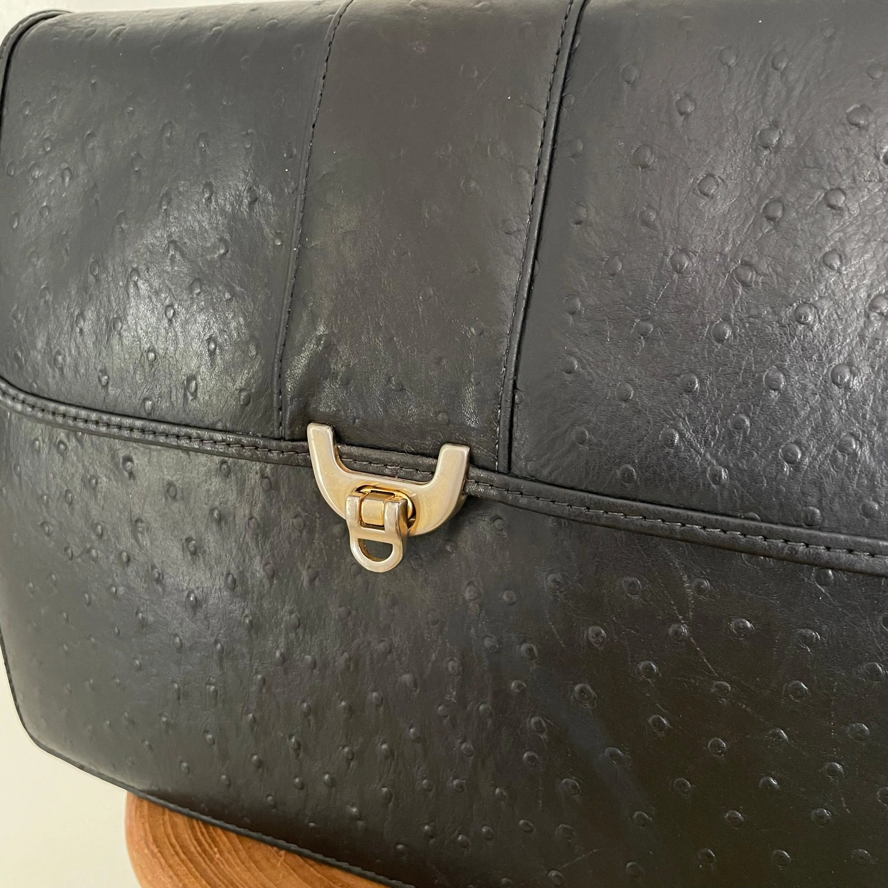 Vintage 1980s black leather bag with detailed front gold clasp